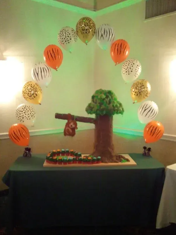 A table with a tree and balloons on it