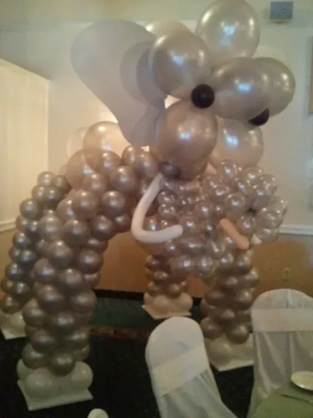 An elephant made out of balloons in a room