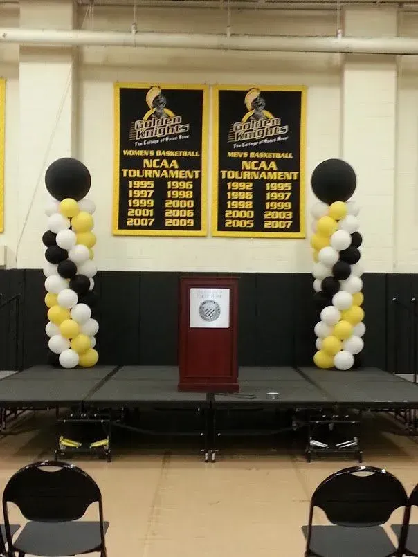 A podium with balloons and banners that say ncaa tournament