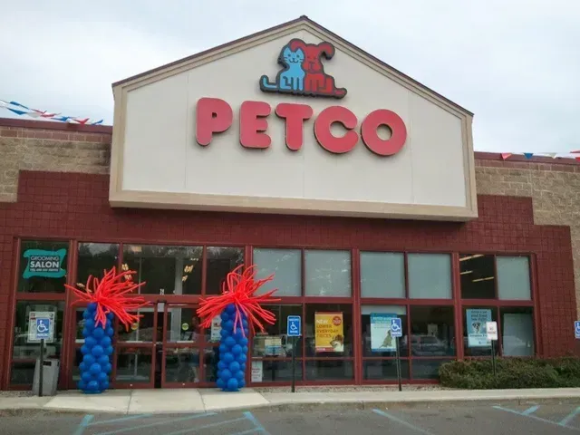 A petco store with balloons in front of it
