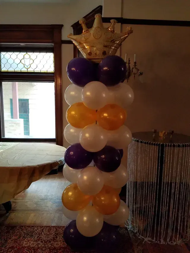 A tower of balloons with a crown on top