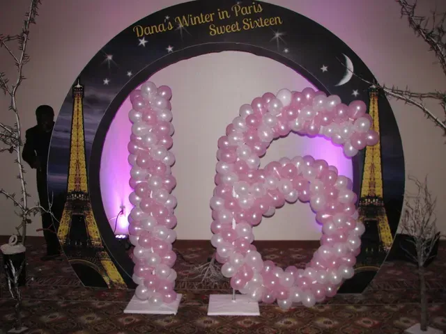 The number 16 is made of pink and white balloons