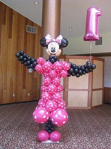A minnie mouse made out of pink and black balloons