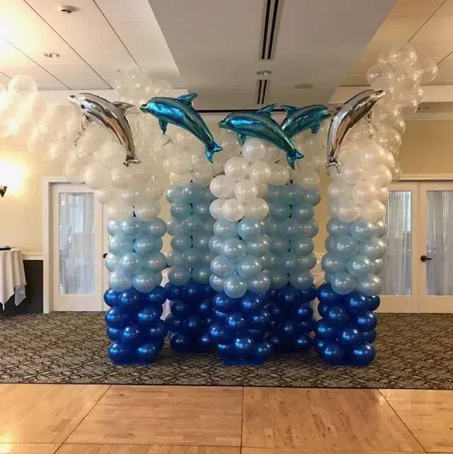 A room filled with blue and white balloons and dolphins