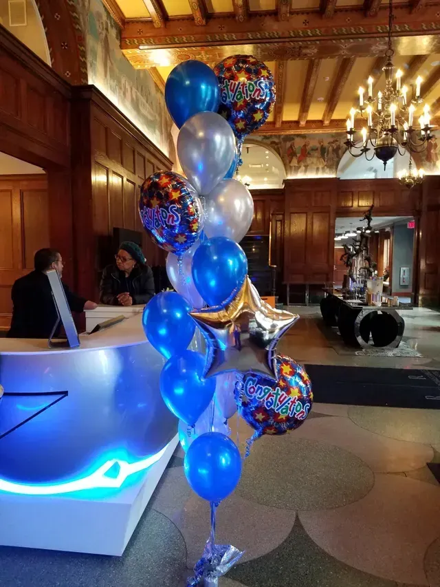 A bunch of balloons are sitting on a table in a room.
