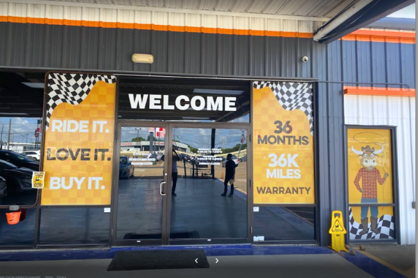 a car dealership with a sign that says welcome