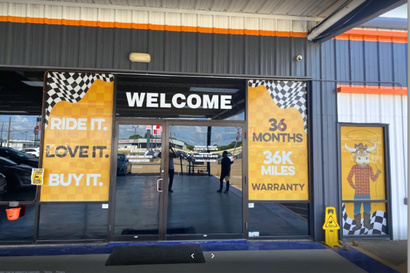 a car dealership with a sign that says welcome