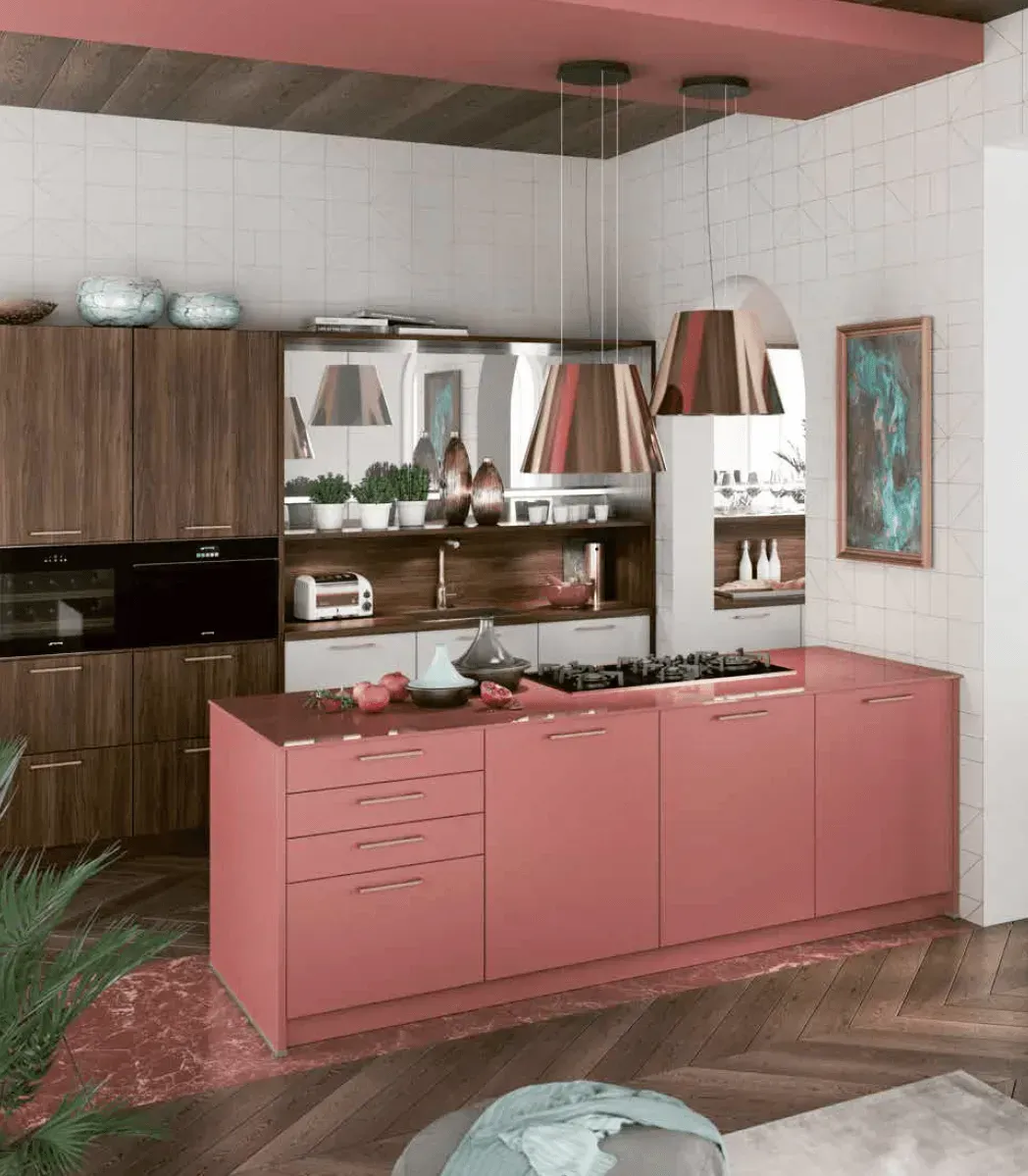 Modern kitchen with pink island, copper pendant lights, and dark wood cabinets.
