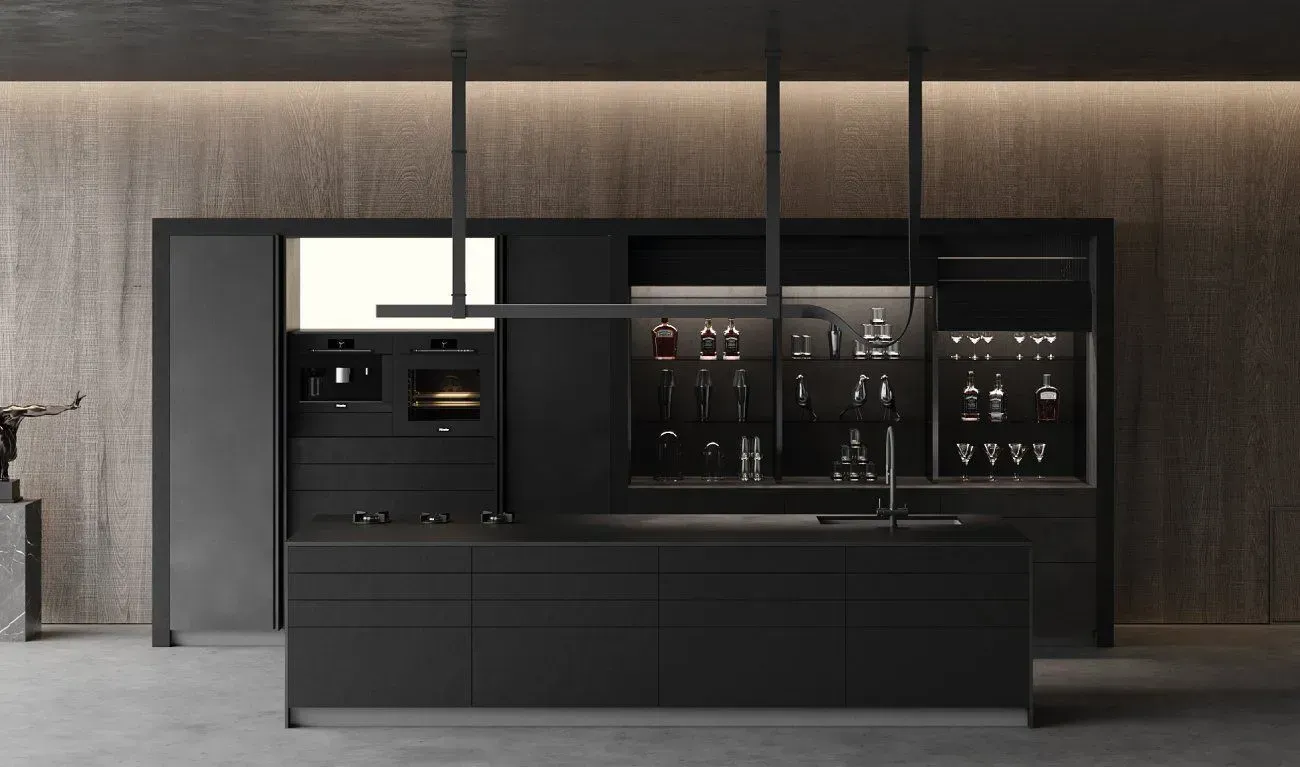 Modern black kitchen with island, appliances, and illuminated liquor display, dark and minimalist.