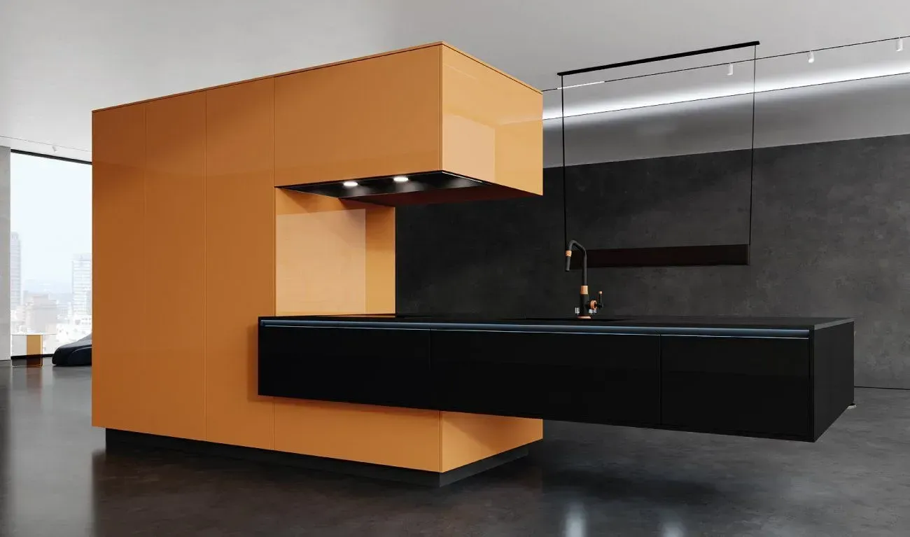Orange and black modern kitchen island with overhead lights.