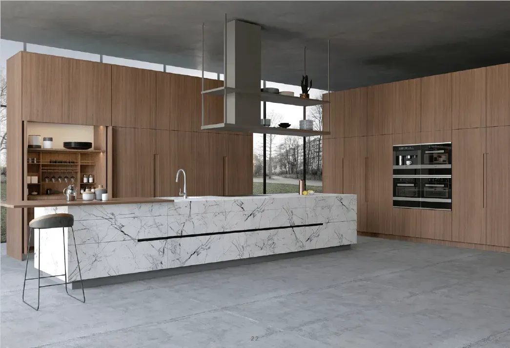 Modern kitchen with marble island, light wood cabinetry, stainless steel appliances, and large windows.