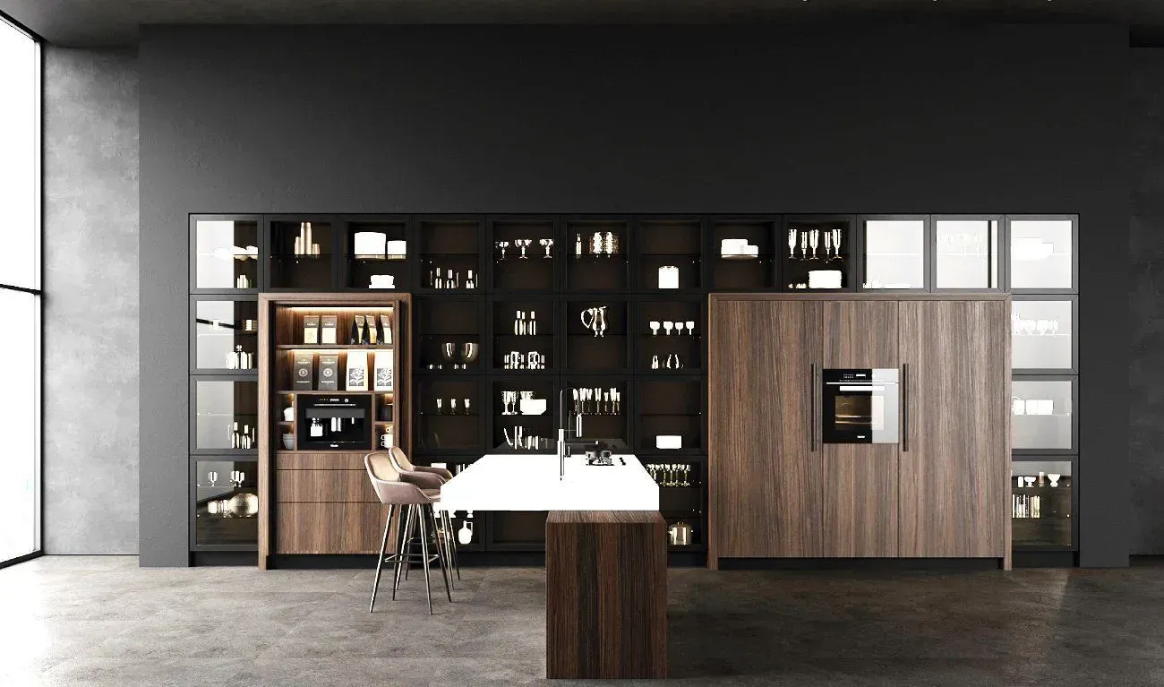 Modern kitchen with wood cabinetry, island, and dark display shelves against a gray wall.