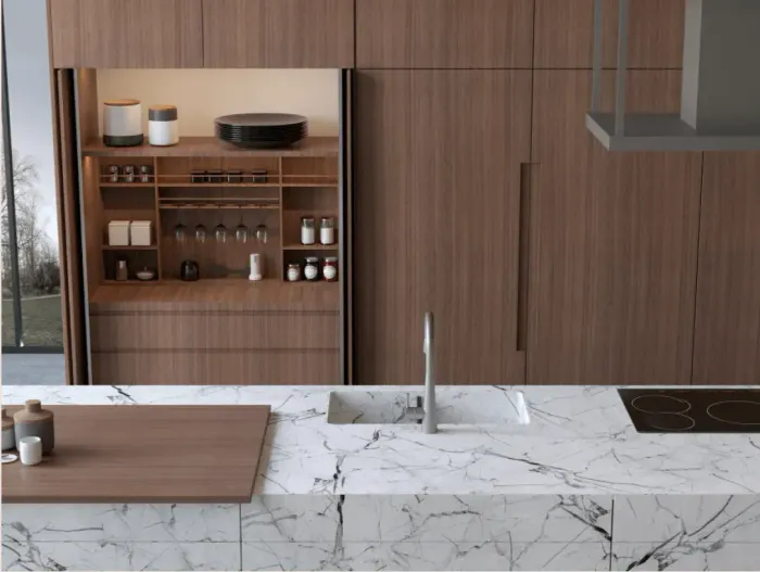 Modern kitchen with marble countertop, wooden cabinets, and built-in shelving for glassware and spices.