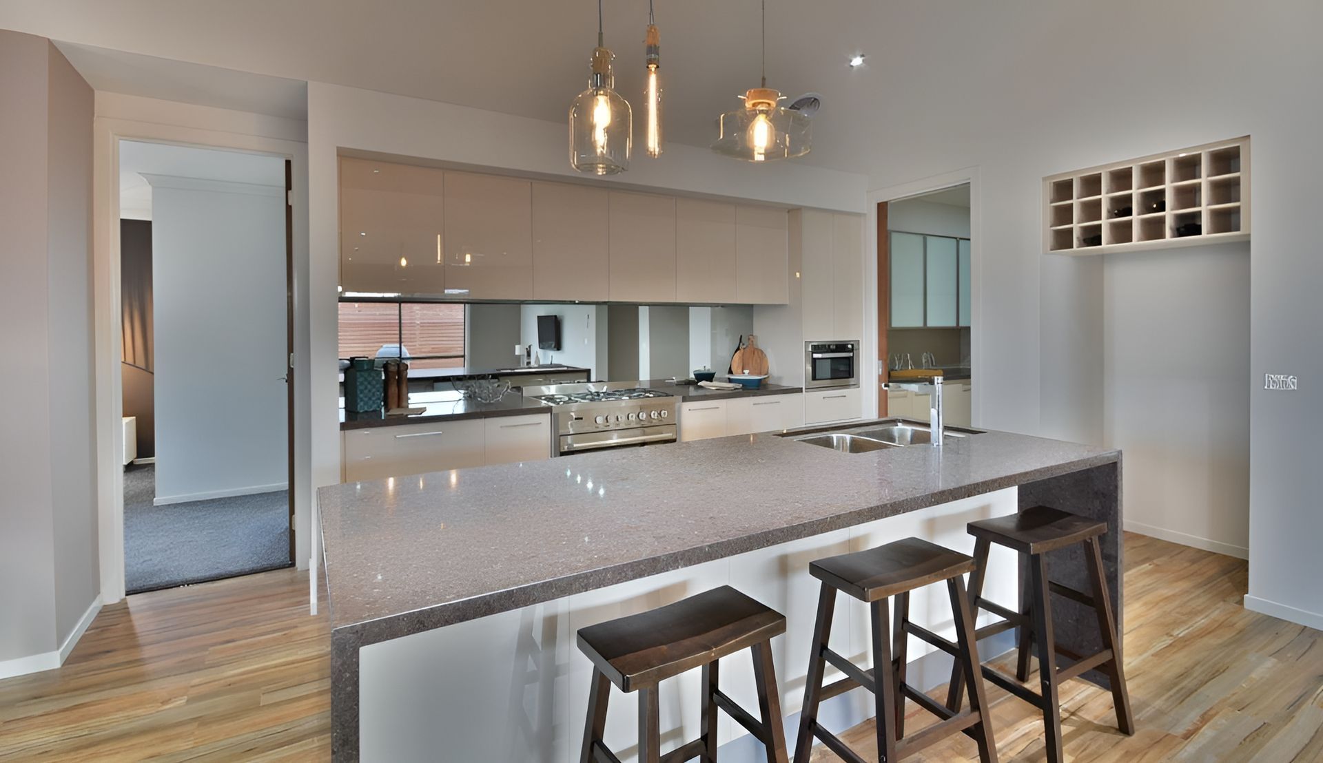 A Kitchen With A Large Island And Stools — Lamont Builders In Woonona, NSW