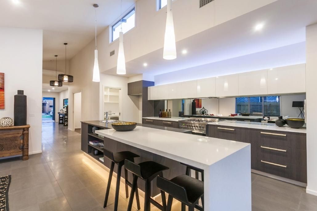 A Kitchen With a Large Island and Stools — Lamont Builders In Woonona, NSW