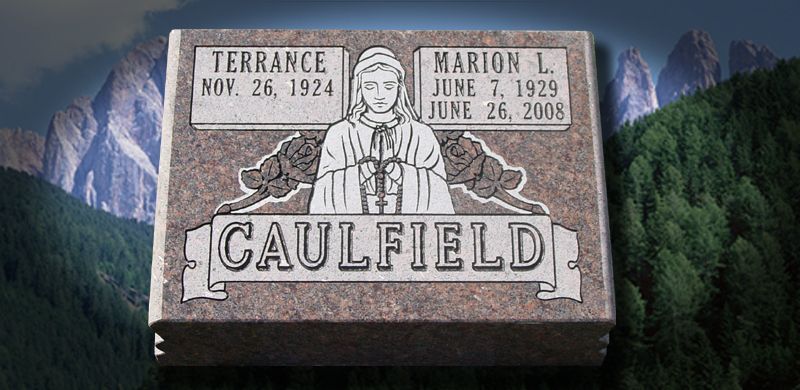 A gravestone for Terrance (1924) and Marion L. Caulfield (1929-2008), with an engraved praying figure. Mountains in the background.