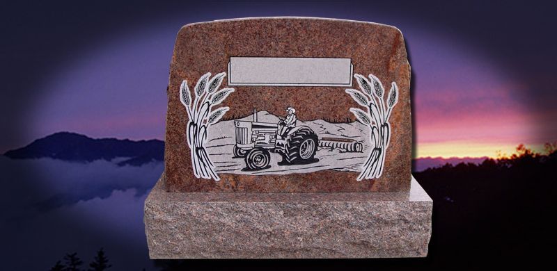 A tombstone featuring a tractor engraving with a sunset background.