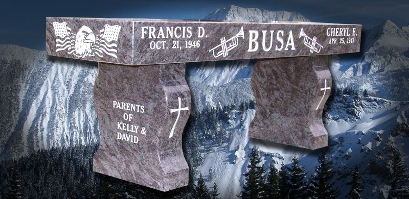 Granite bench with engraved names and dates, set against a mountainous landscape.