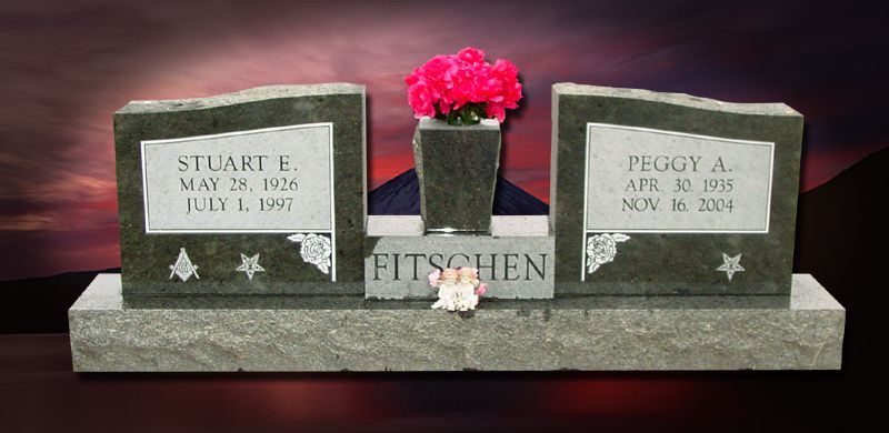 A double tombstone with flowers, bearing the names Stuart E. and Peggy A. Fischen.