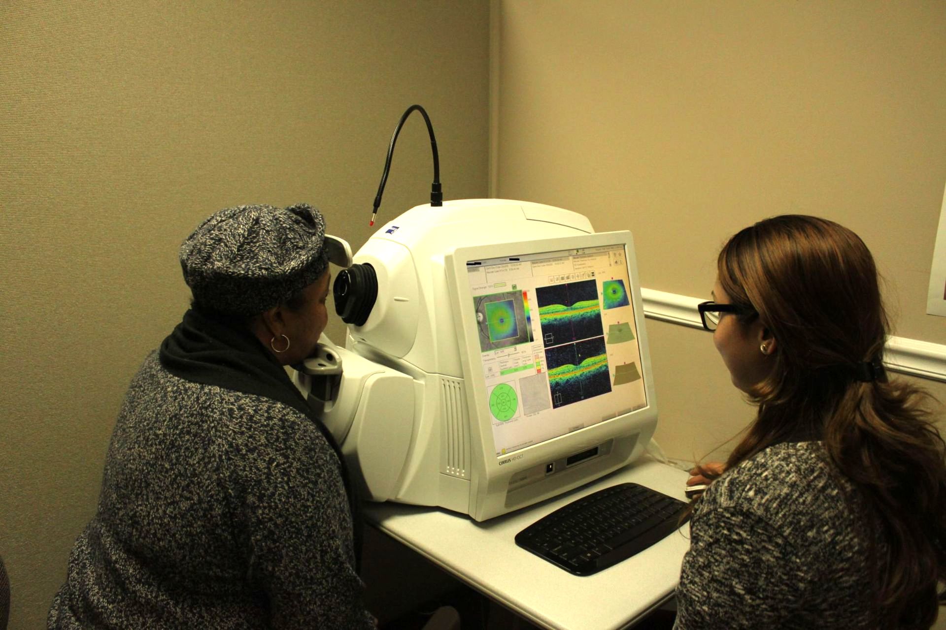 Eye Care and Surgery provider performs OCT aqcuisition on female patient to examine retina