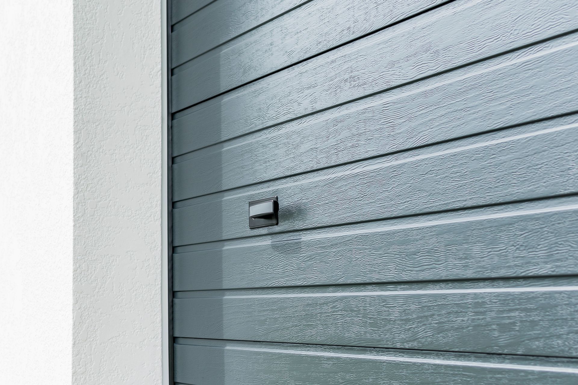 A close up of a garage door with a handle on it.