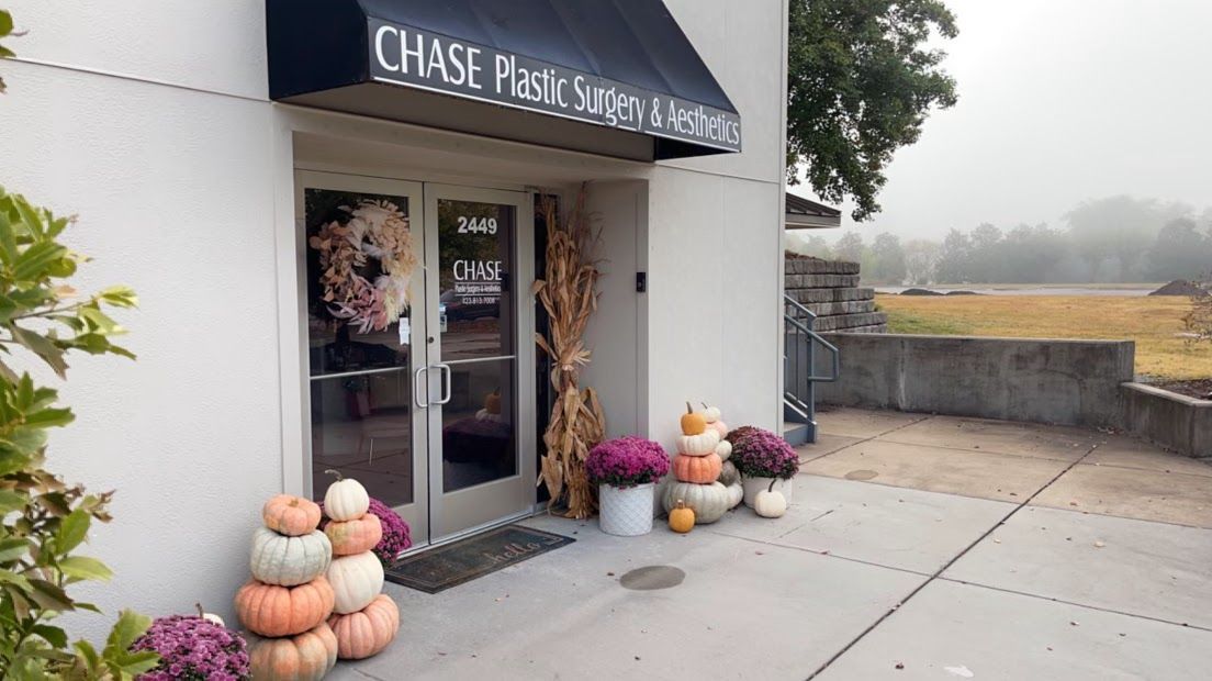Exterior of Chase Plastic Systems & Components building with fall decorations.