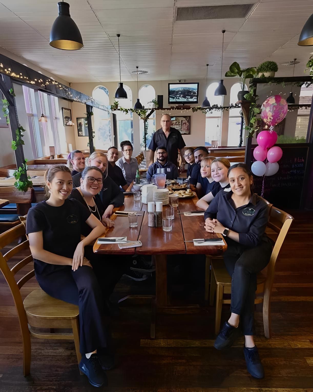A Group of People Are Sitting at a Long Table in a Restaurant — The Shire Bar & Grill In Dubbo, NSW
