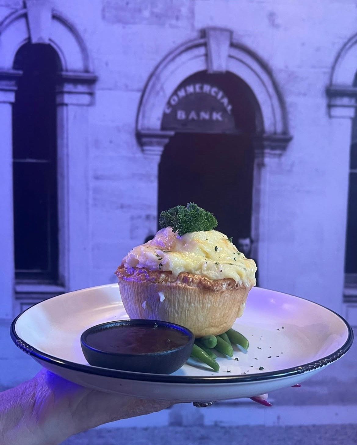 Savory pie topped with mashed potato, served with beans and gravy. — The Shire Bar & Grill In Dubbo, NSW