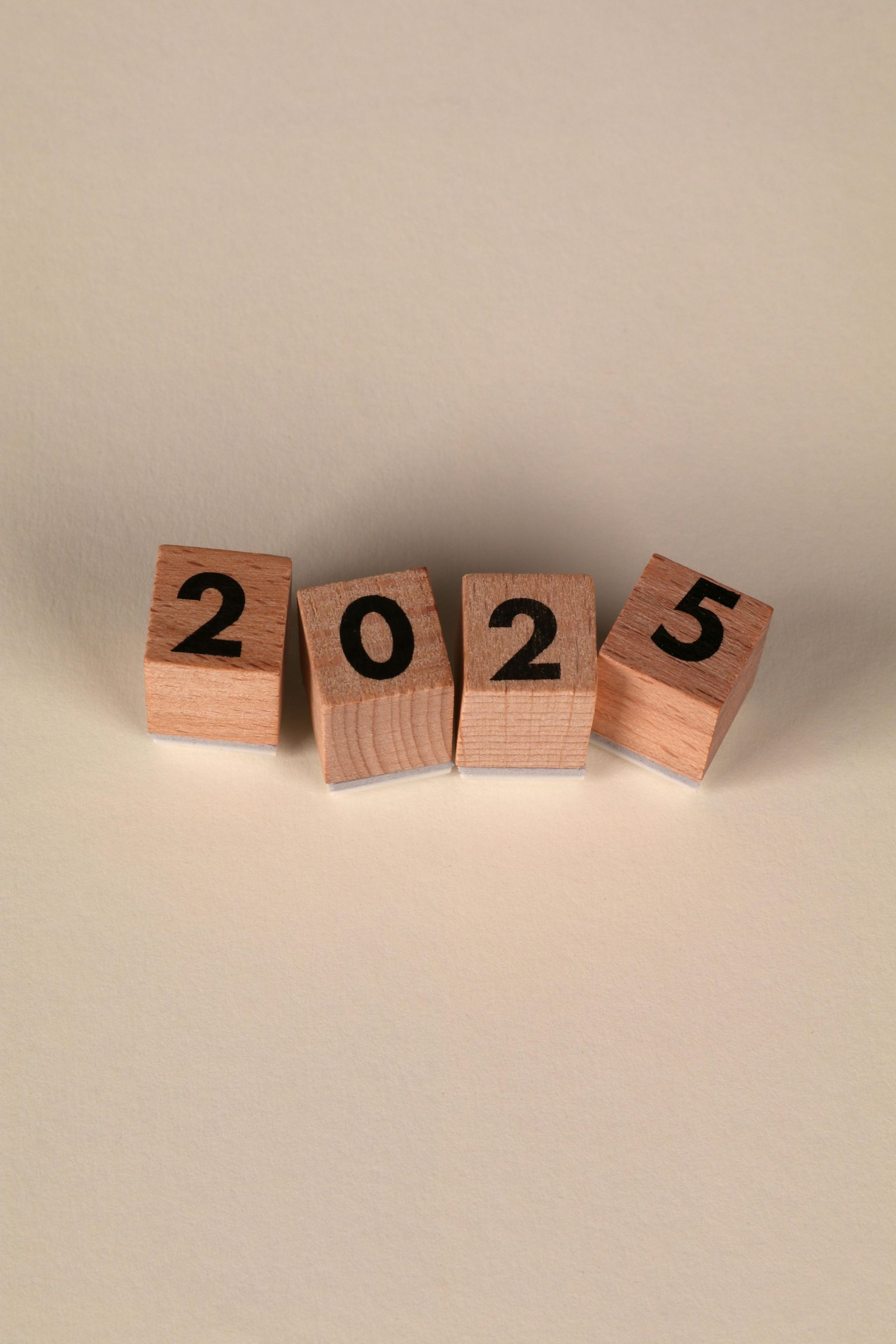 A row of wooden blocks with the numbers 2025 on them.