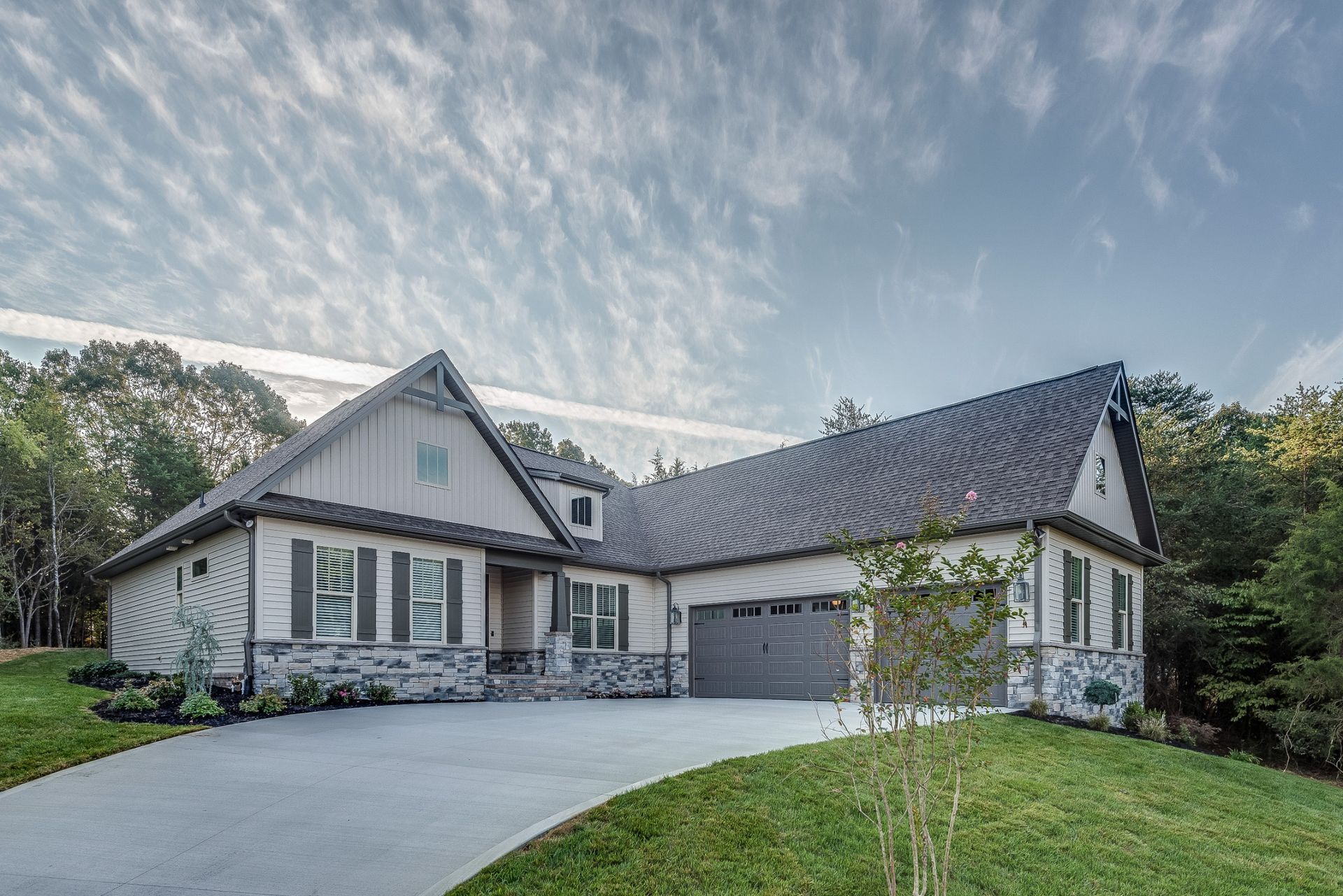 A large house with a garage and a driveway in front of it.