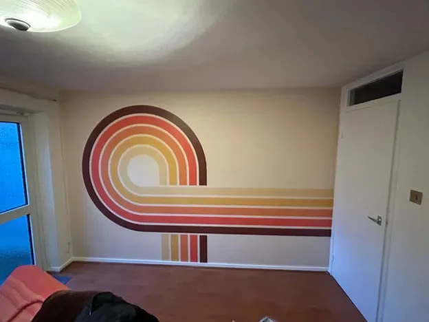 Retro color stripe design painted on a wall in a room.