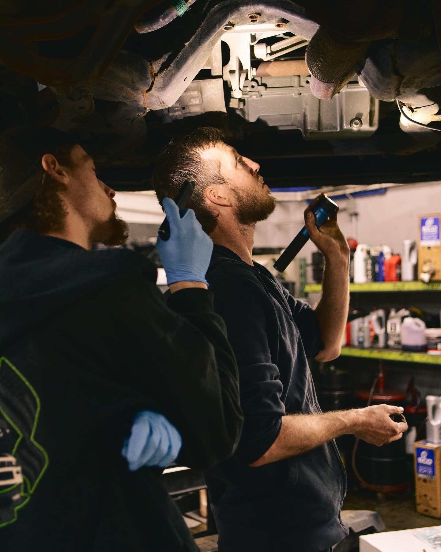 Two mechanics under a car | SK Mechanic