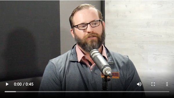 Danny Ahlers from Ahlers Roofing is talking into a microphone about questions your should ask your roofer