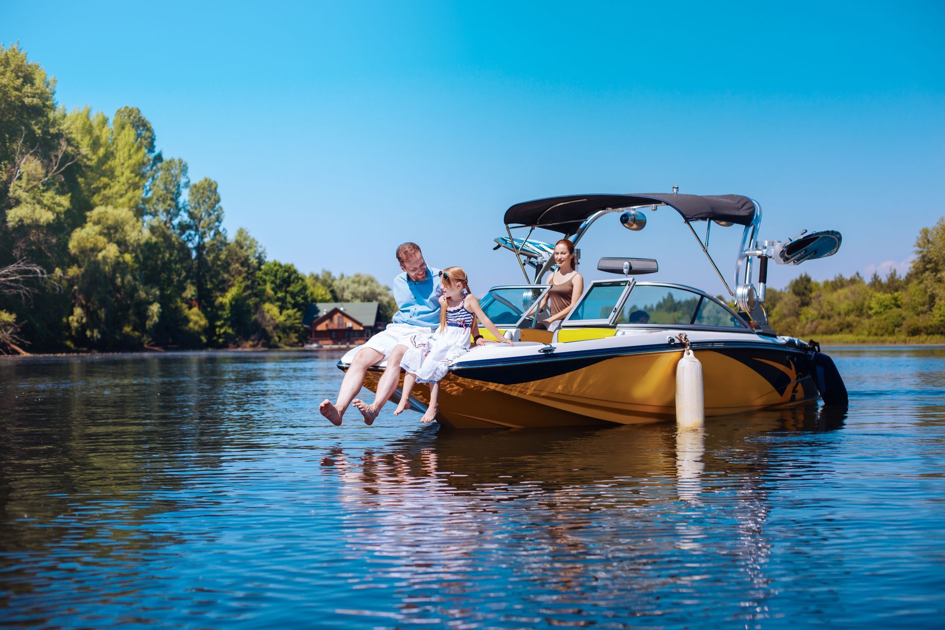 People relaxing on a motorboat on a calm blue lake under a clear sky People relaxing on a motorboat on a calm blue lake under a clear sky