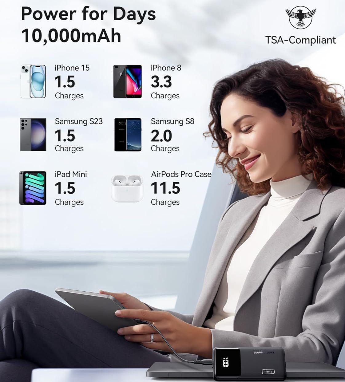 A woman is sitting on a couch looking at a tablet.