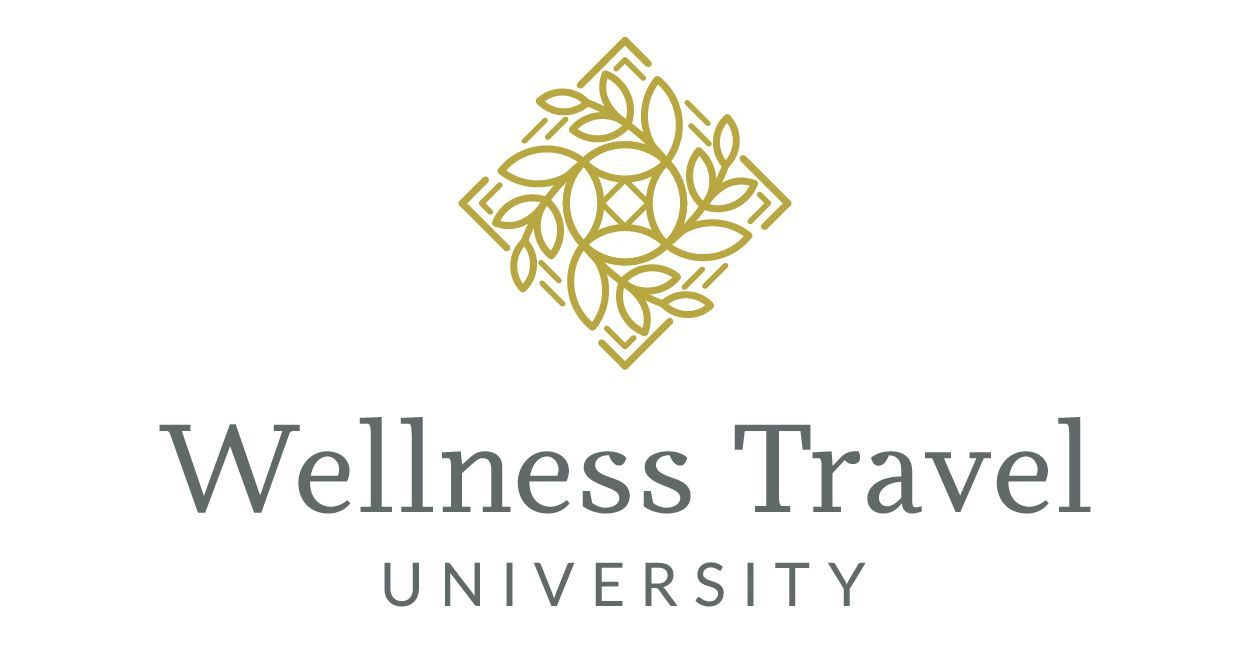 Logo for Wellness Travel University.  Gold geometric design above gray text.