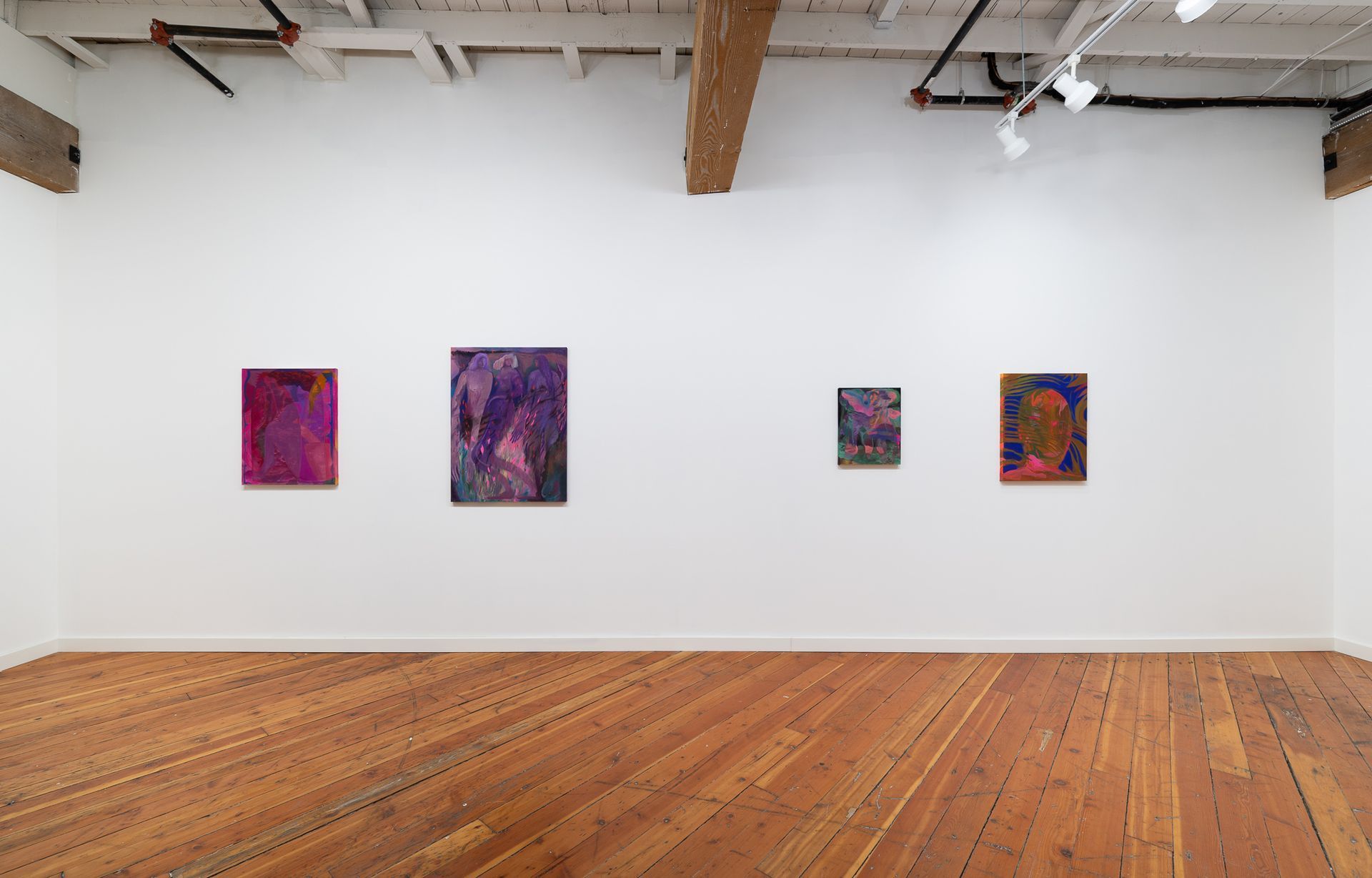 Four abstract paintings by Emily Elizabeth Wise with purple and blue tones hang on a white gallery wall above a wooden floor.