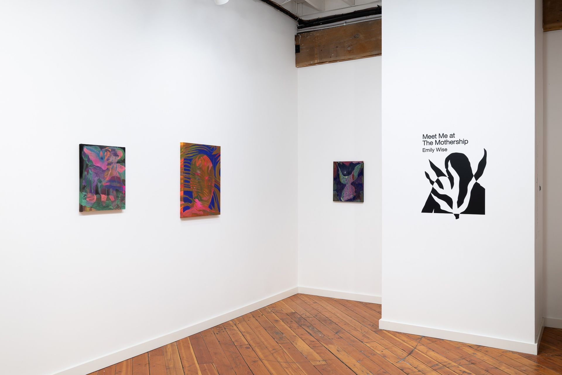 Art gallery corner with three colorful paintings by Emily Elizabeth Wise.