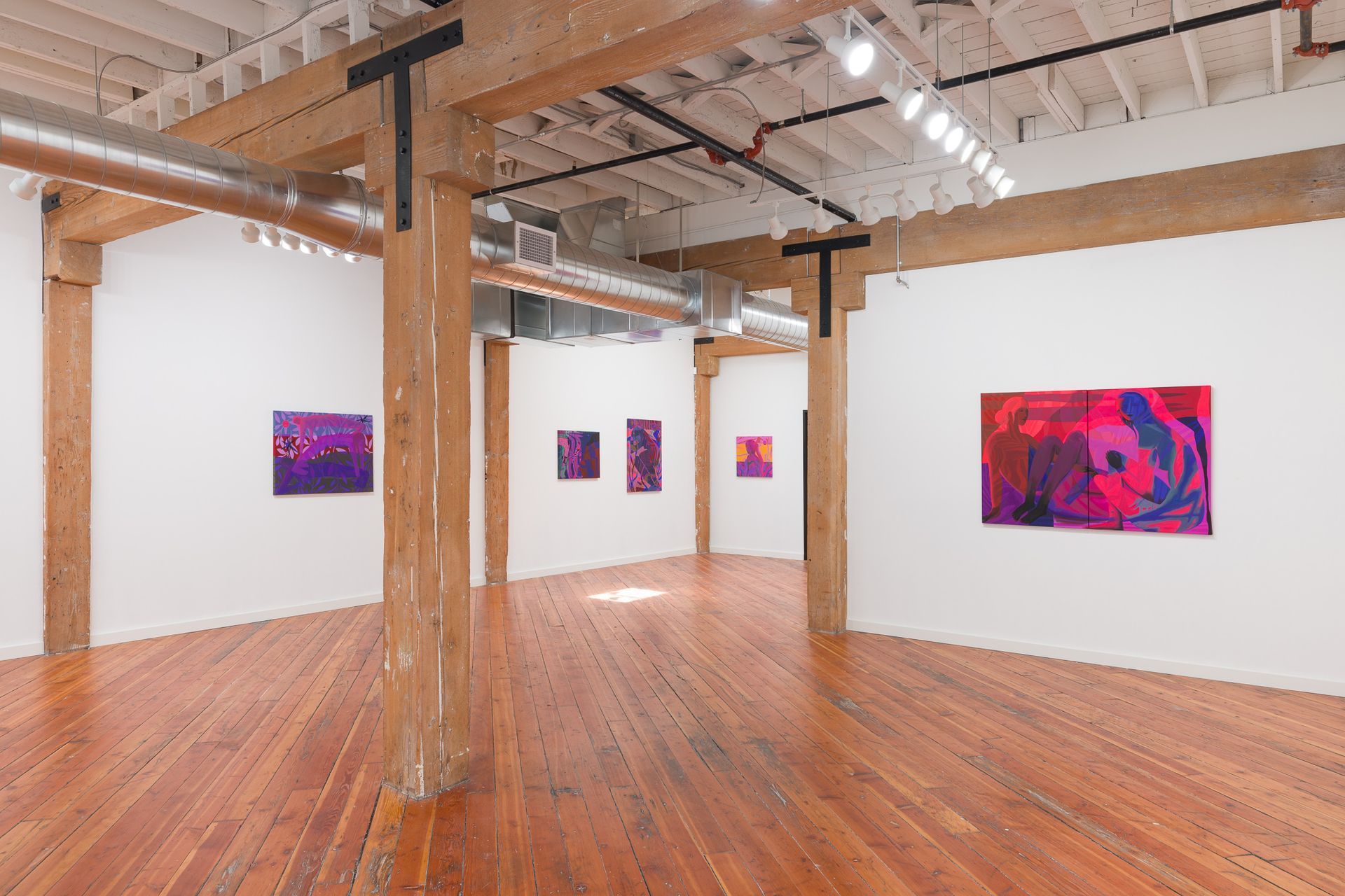 A gallery with modern abstract paintings by Emily Wise in shades of purple and pink. Wooden beams support the ceiling.