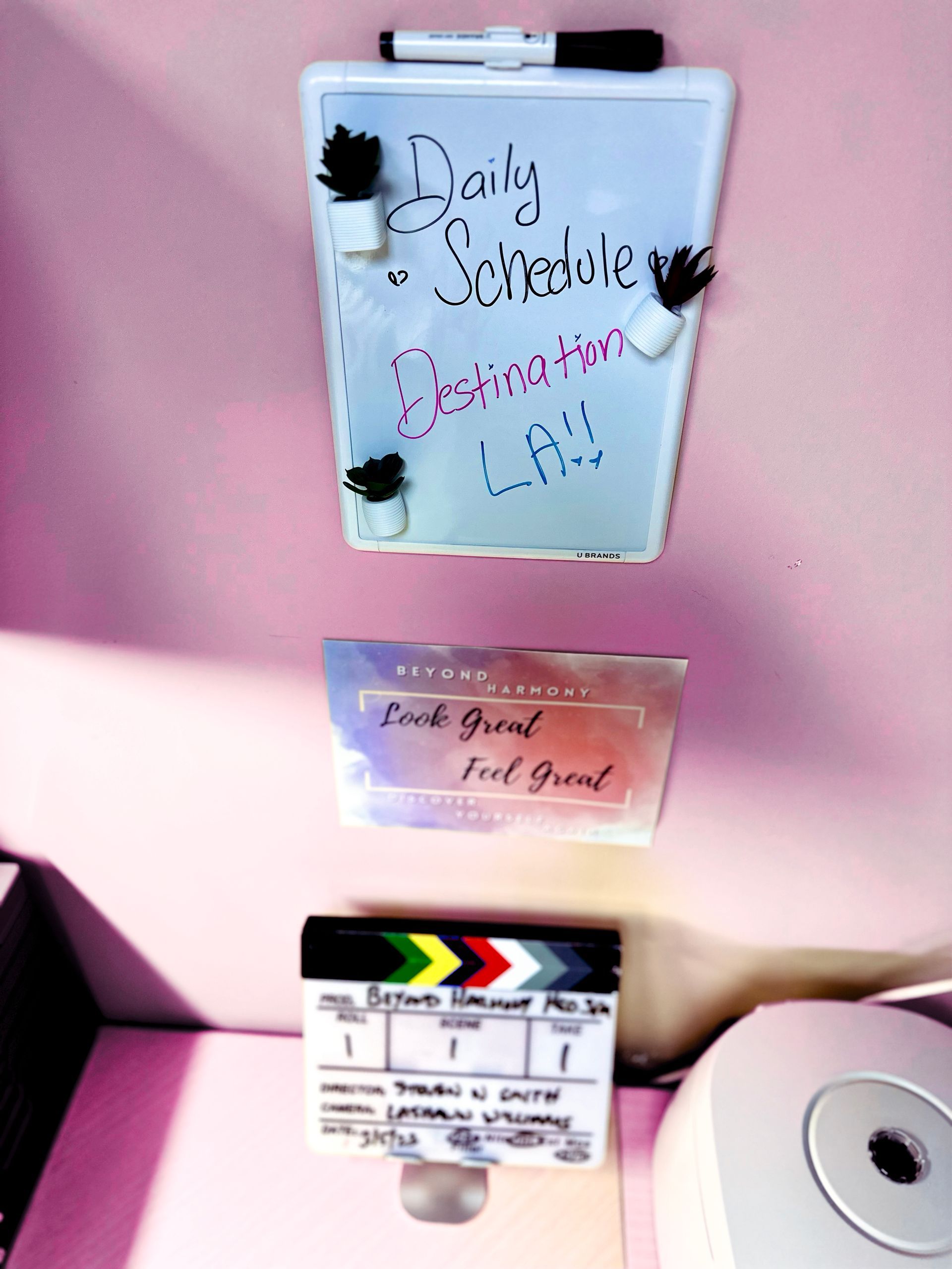 a woman sits in front of a sign for beyond harmony | Valencia, CA | Beyond Harmony Medical Spa