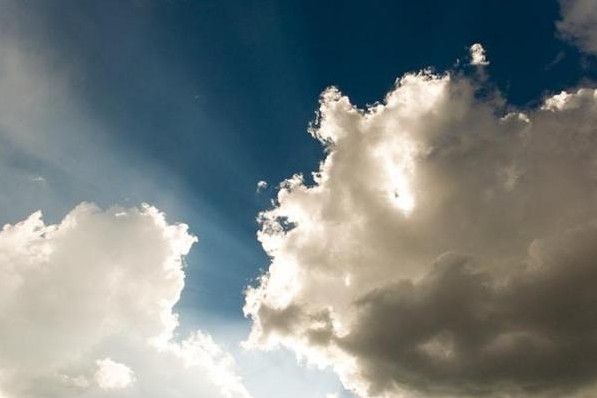 Sunlight breaking through towering clouds creates a hopeful scene for funeral homes Taneytown, MD