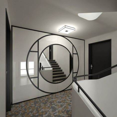 Un escalier se reflète dans un miroir dans un couloir réalisé par mes services d'architecte d'intérieur