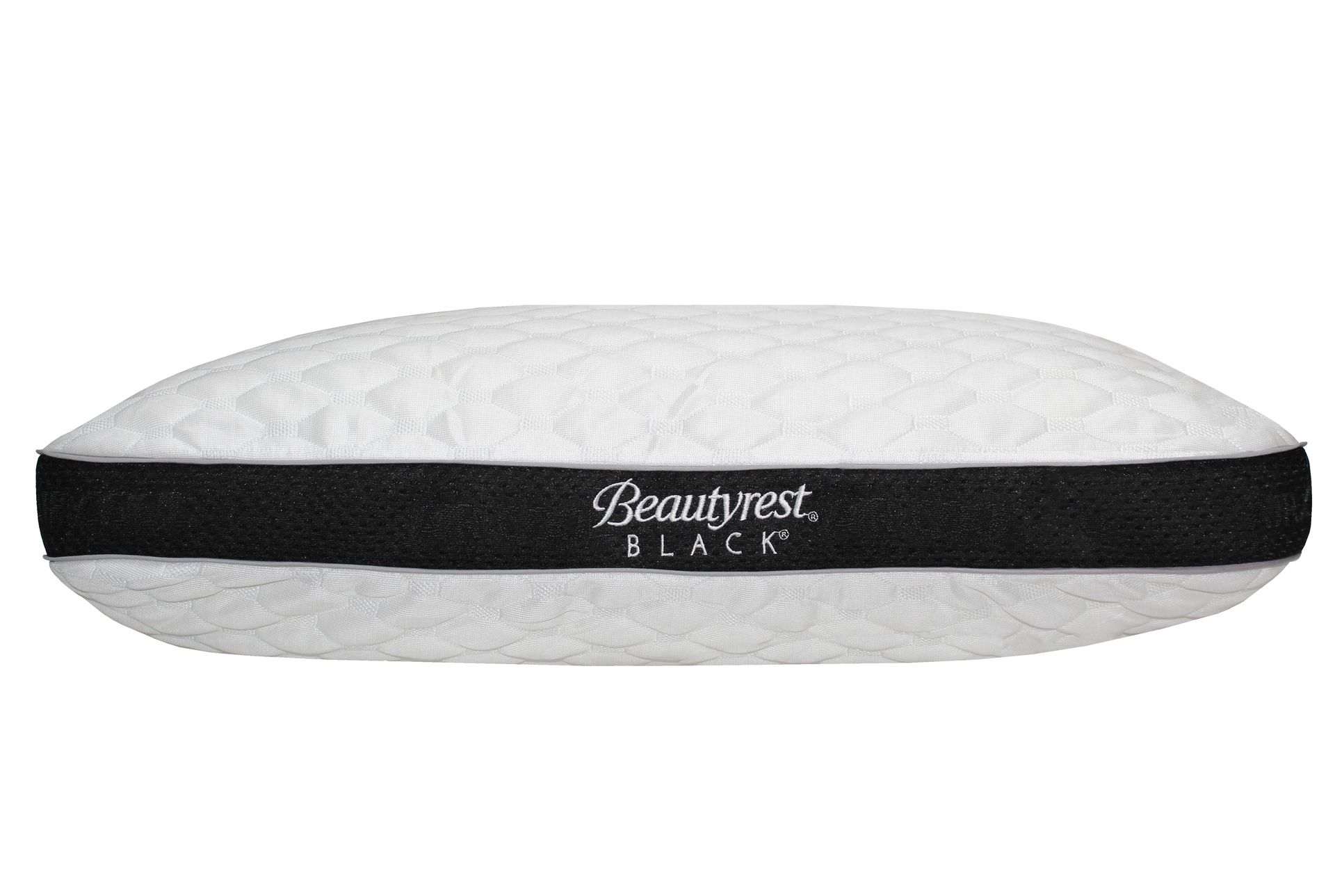 Una almohada negra de belleza está sentada sobre una superficie blanca.