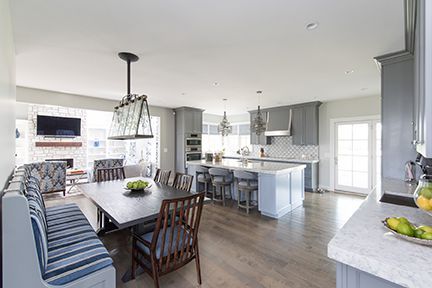 Open kitchen with a large island, dining table, and built-in bench seating.