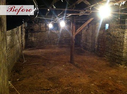 Before: A dark, unfinished basement with exposed stone walls, dirt floor, support beams, and overhead lights.
