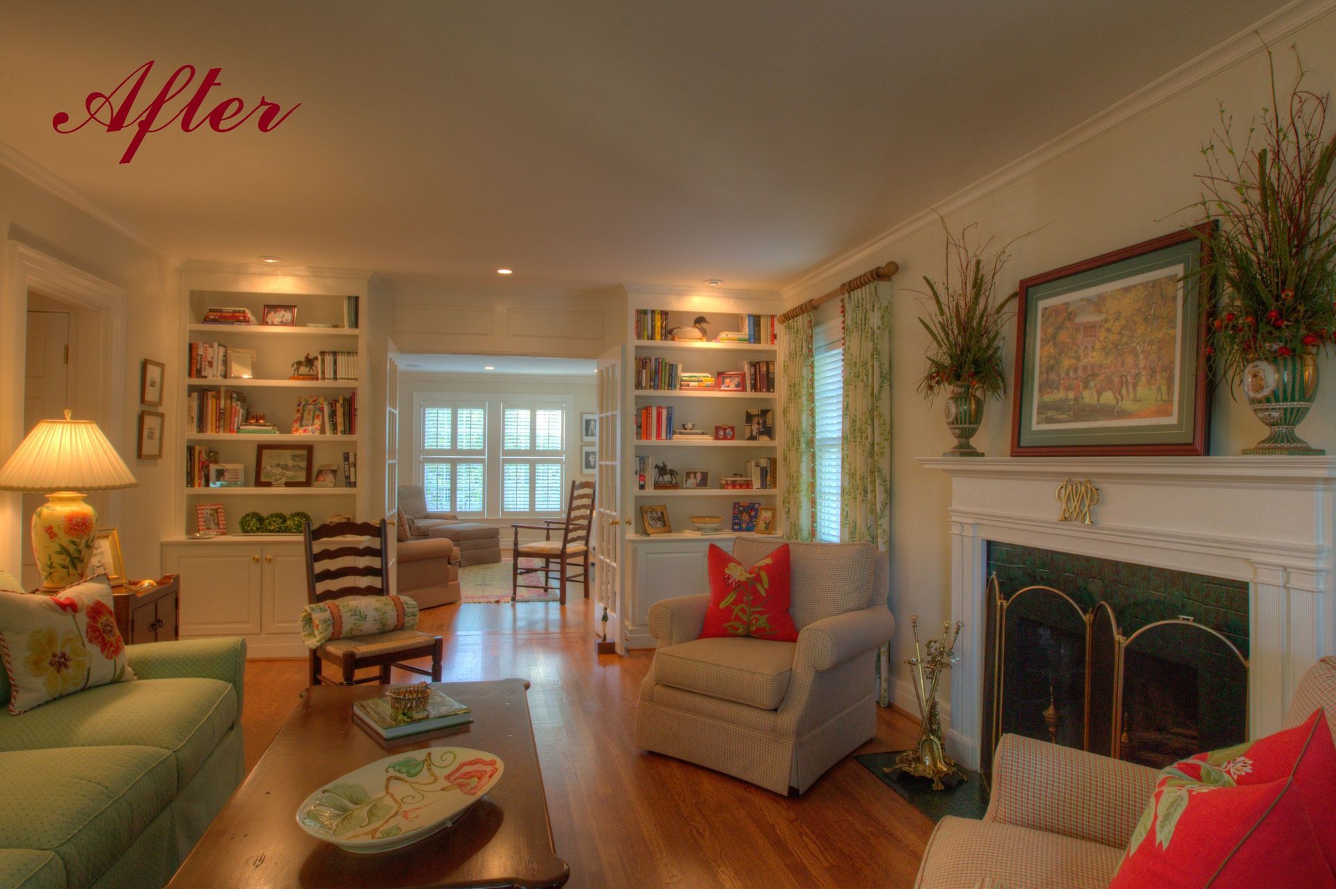 Cozy living room with built-in bookshelves, fireplace, and comfortable furniture. Sunlight streams in.
