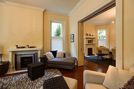 Living room with fireplace, chaise lounge, and doorway to dining area.
