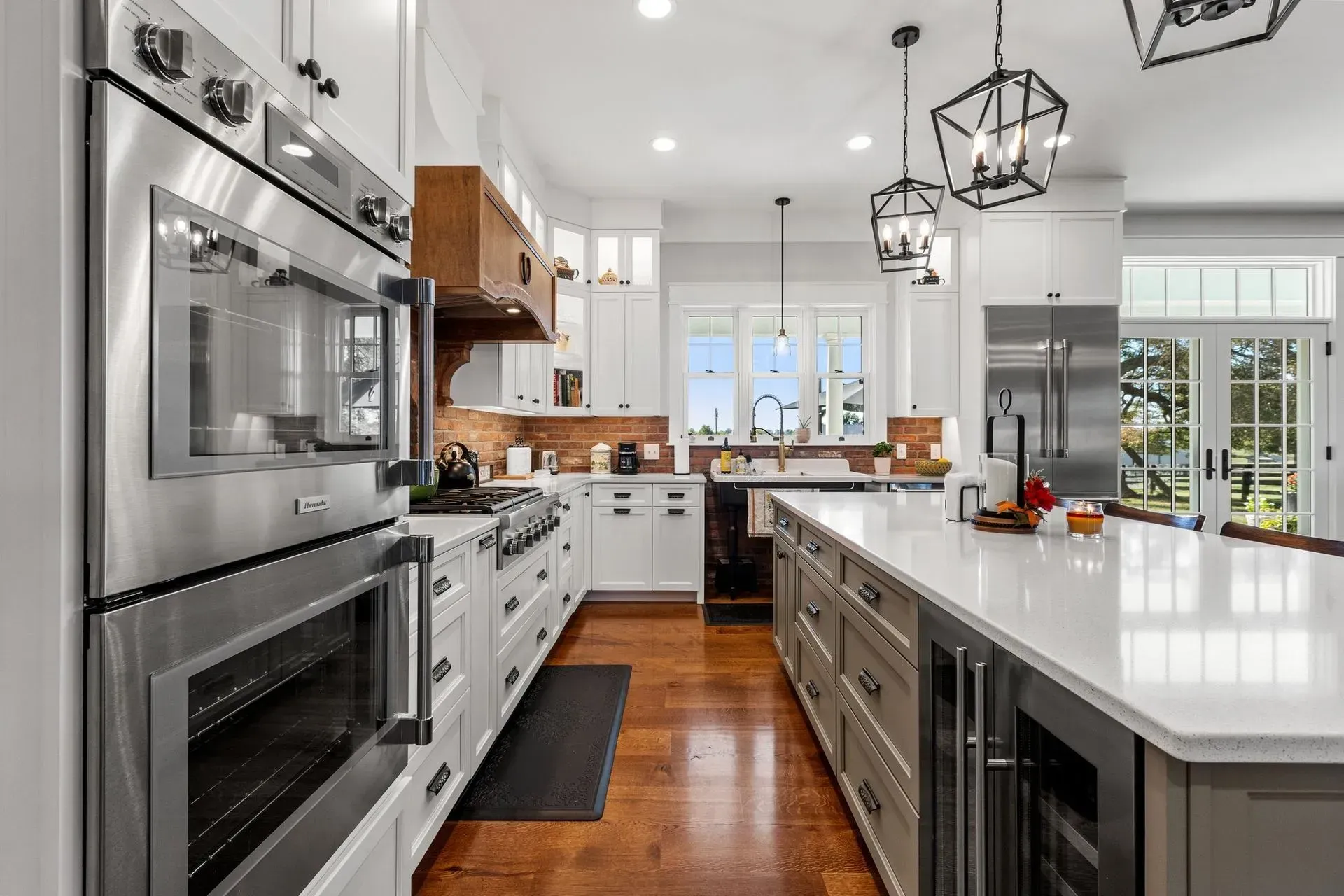 Bright, modern kitchen with stainless steel appliances, white cabinets, and a large island.