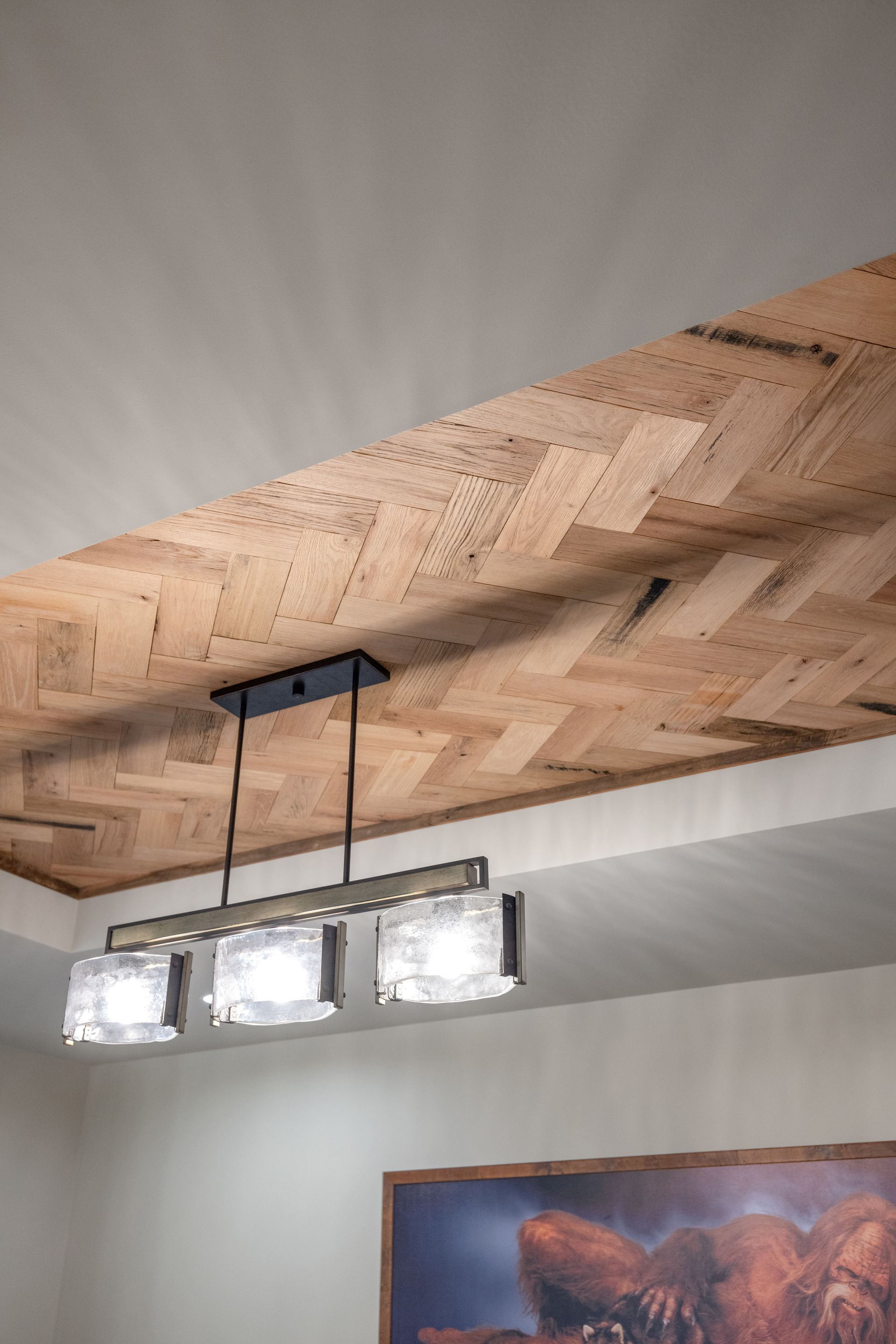 Cork ceiling with a rectangular black light fixture and three square frosted glass lights.