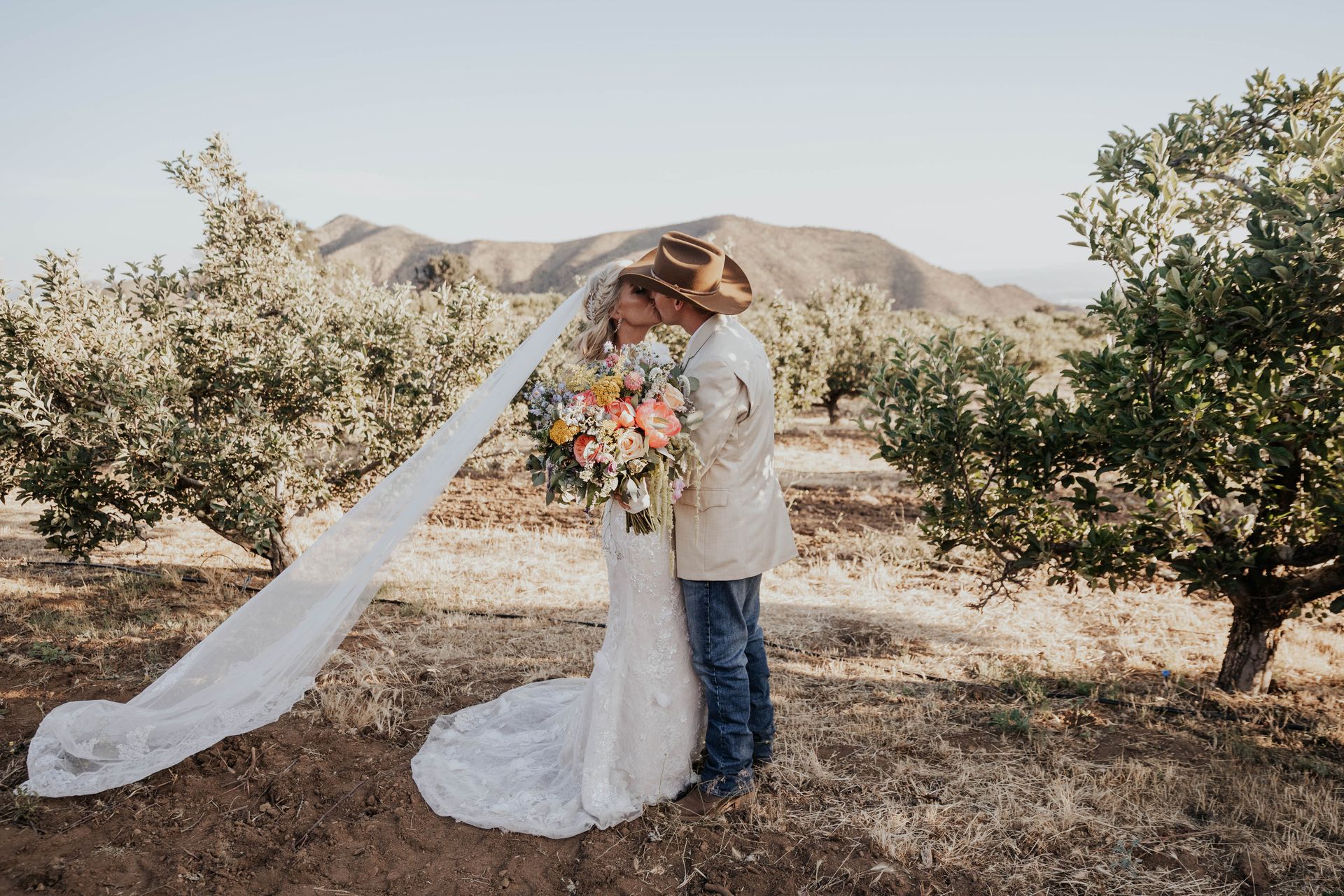 A bride and groom are hugging each other on their wedding day after their wedding veremony.